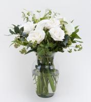 Arrangement of white roses and calla lilies that sends your sympathy in the most elegant way