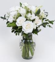 Provide sweet solace to the bereaved with this pure white arrangement of roses, callas and foliage