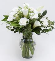 Sympathy arrangement of white premium roses, calla lilies and lush foliage